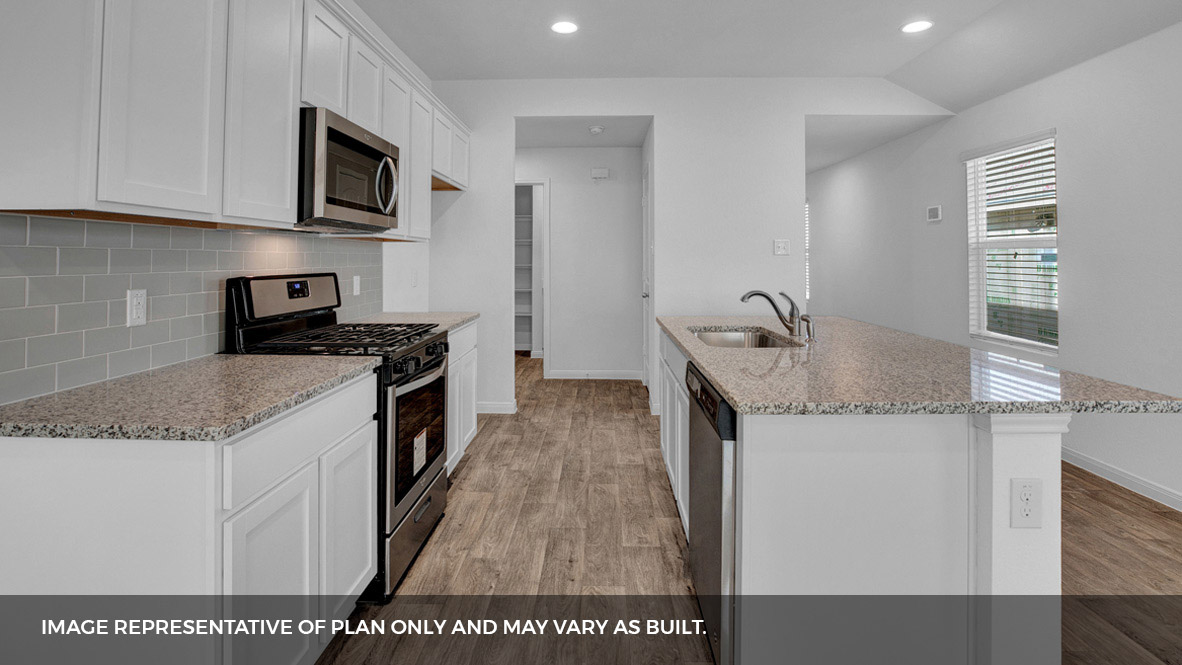 268 Mountain Pea Road Kyle, TX 78640 - Photo 5 of 18 a kitchen with stainless steel appliances granite countertop a sink stove and microwave
