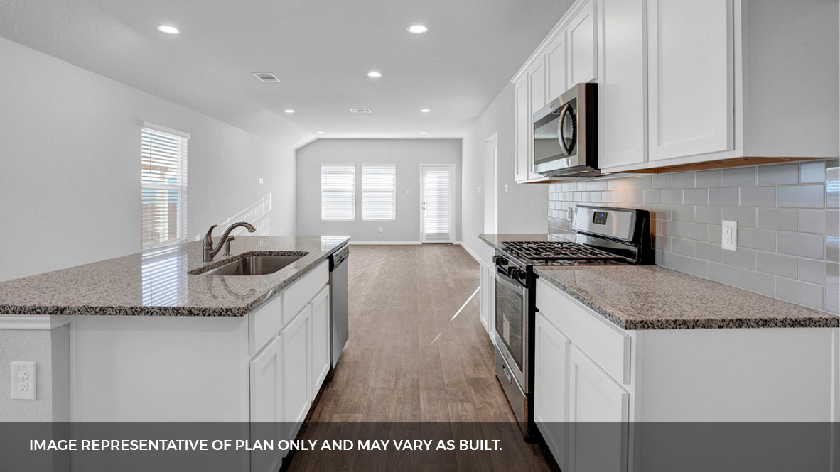 268 Mountain Pea Road Kyle, TX 78640 - Photo 7 of 18 a kitchen with stainless steel appliances granite countertop a sink a stove and a microwave