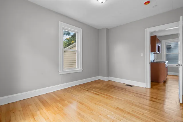 a view of a livingroom with wooden floor and a window