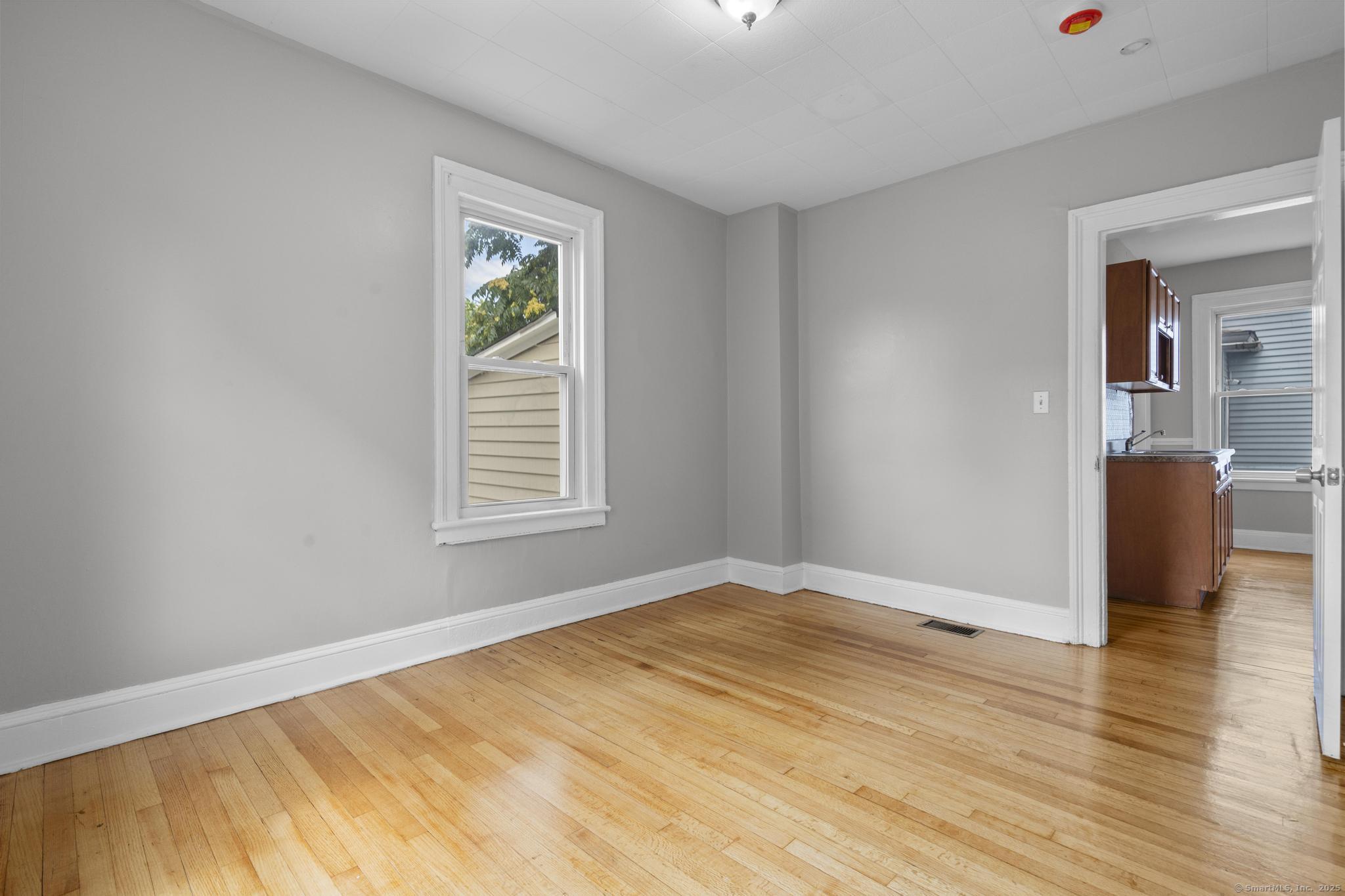857 Noble Avenue, Unit 1 Bridgeport, CT 06608 - Photo 11 of 16 a view of a livingroom with wooden floor and a window