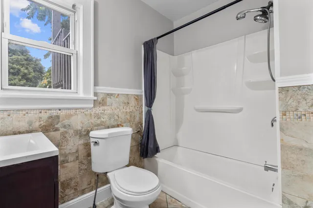 a bathroom with a toilet and a shower