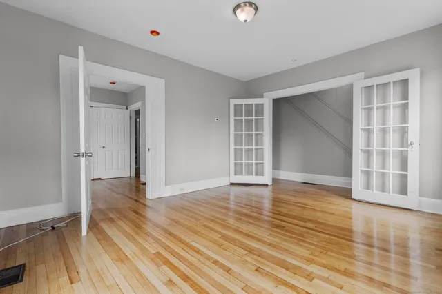 wooden floor in an empty room with a window