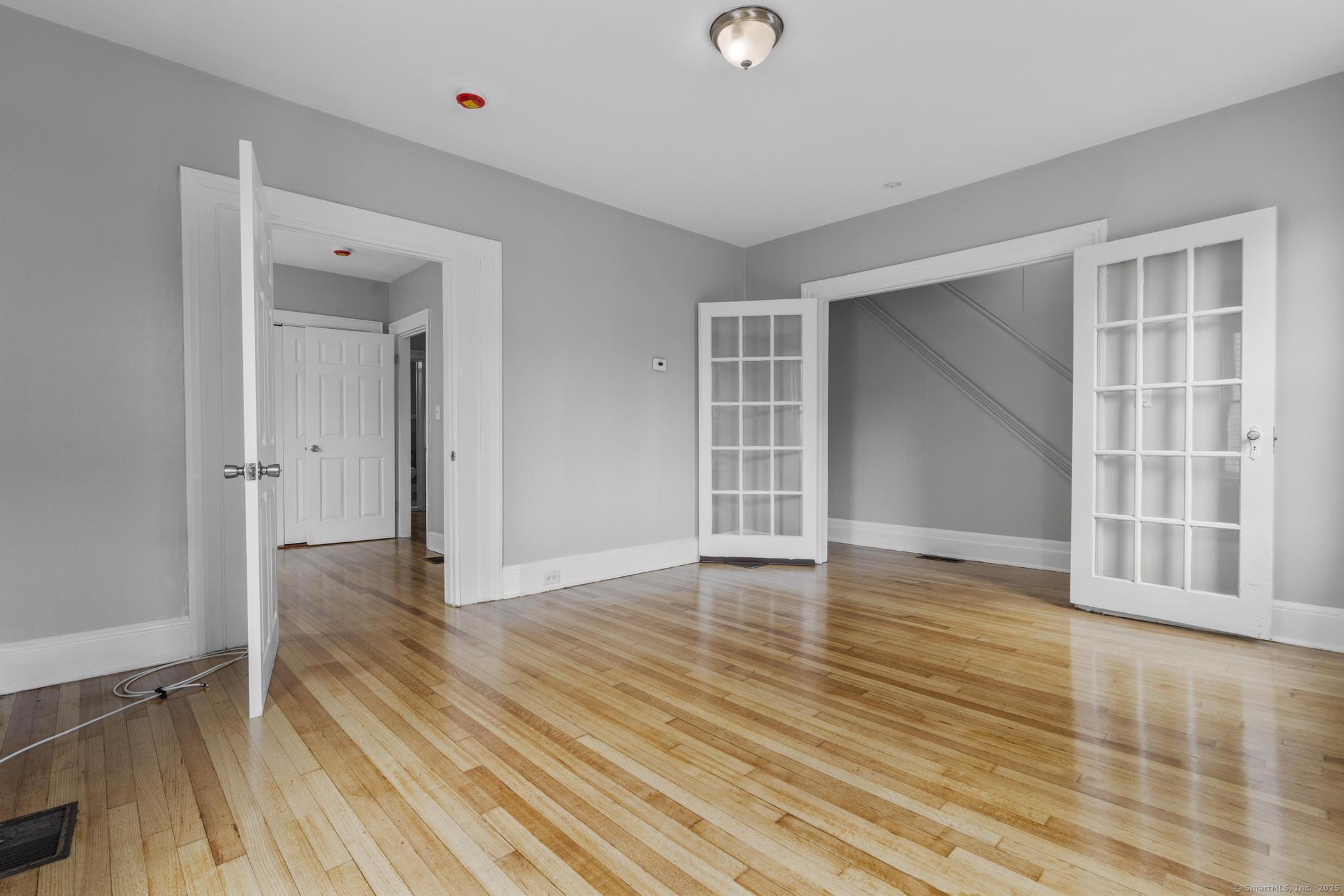 857 Noble Avenue, Unit 1 Bridgeport, CT 06608 - Photo 2 of 16 wooden floor in an empty room with a window