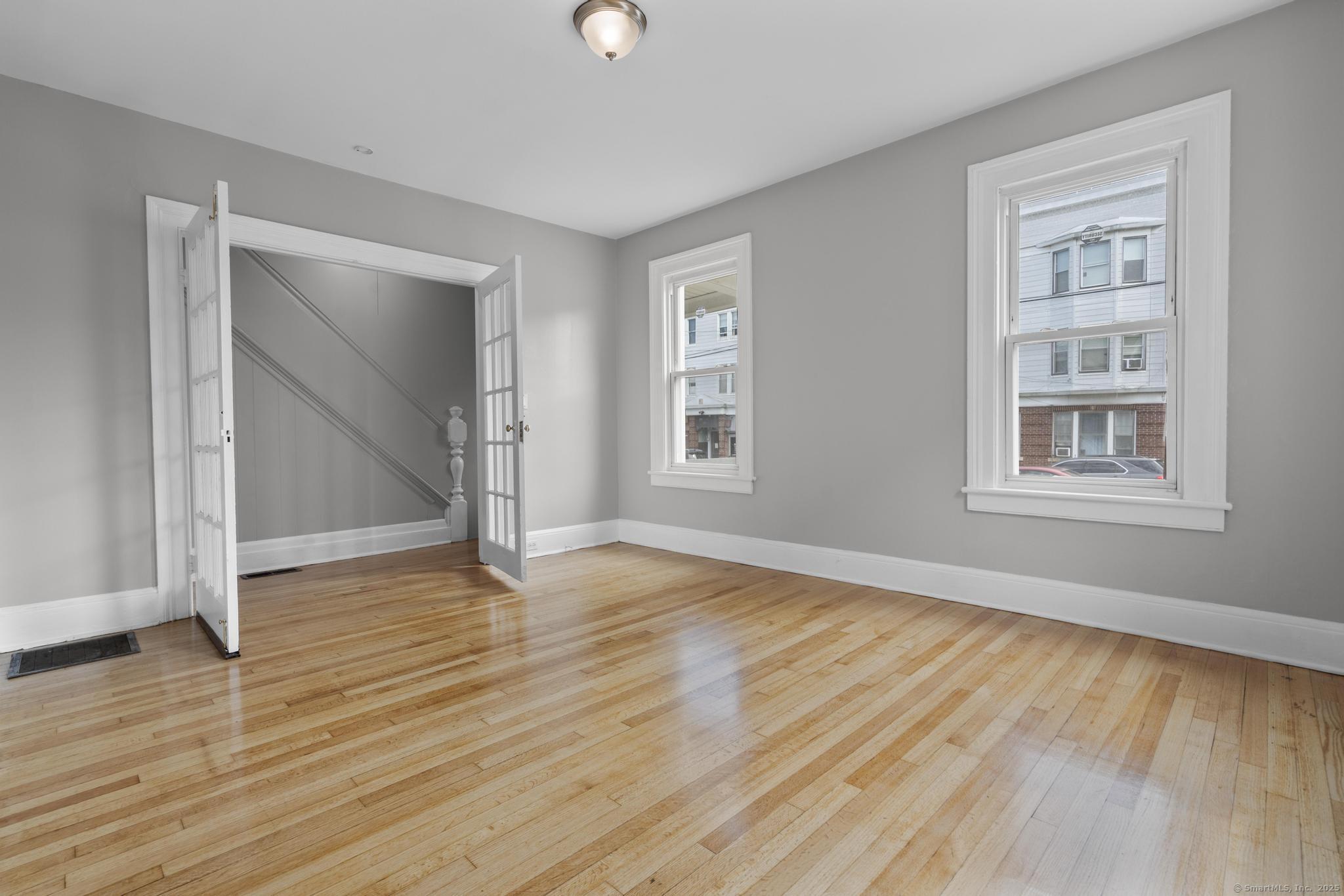 857 Noble Avenue, Unit 1 Bridgeport, CT 06608 - Photo 4 of 16 a view of empty room with wooden floor and fan