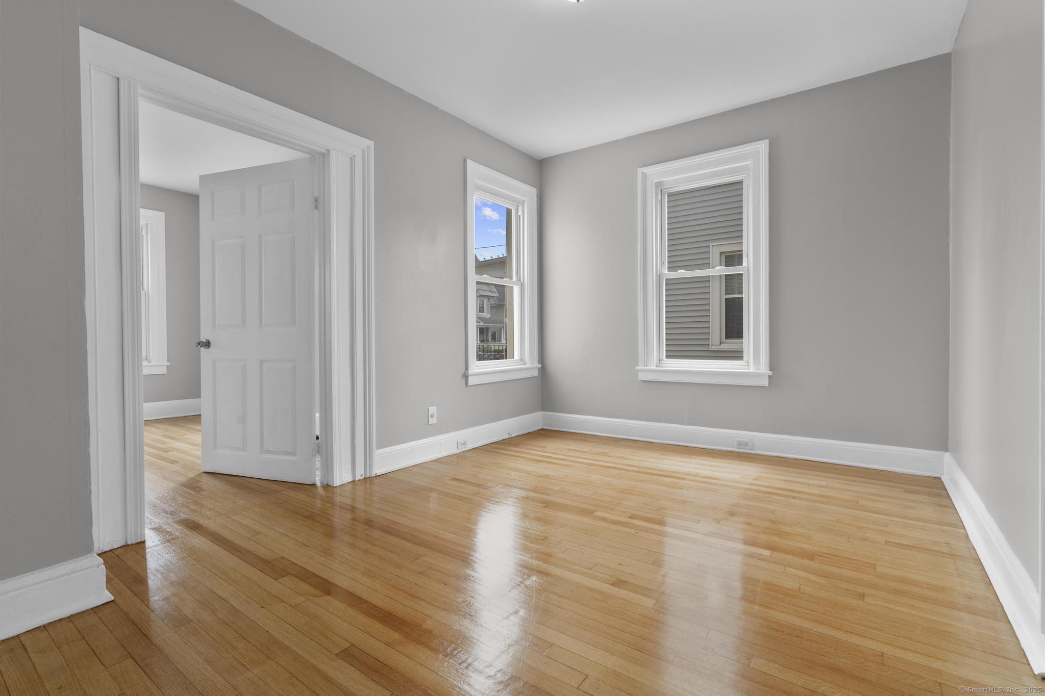 857 Noble Avenue, Unit 1 Bridgeport, CT 06608 - Photo 7 of 16 a view of empty room with wooden floor and fan
