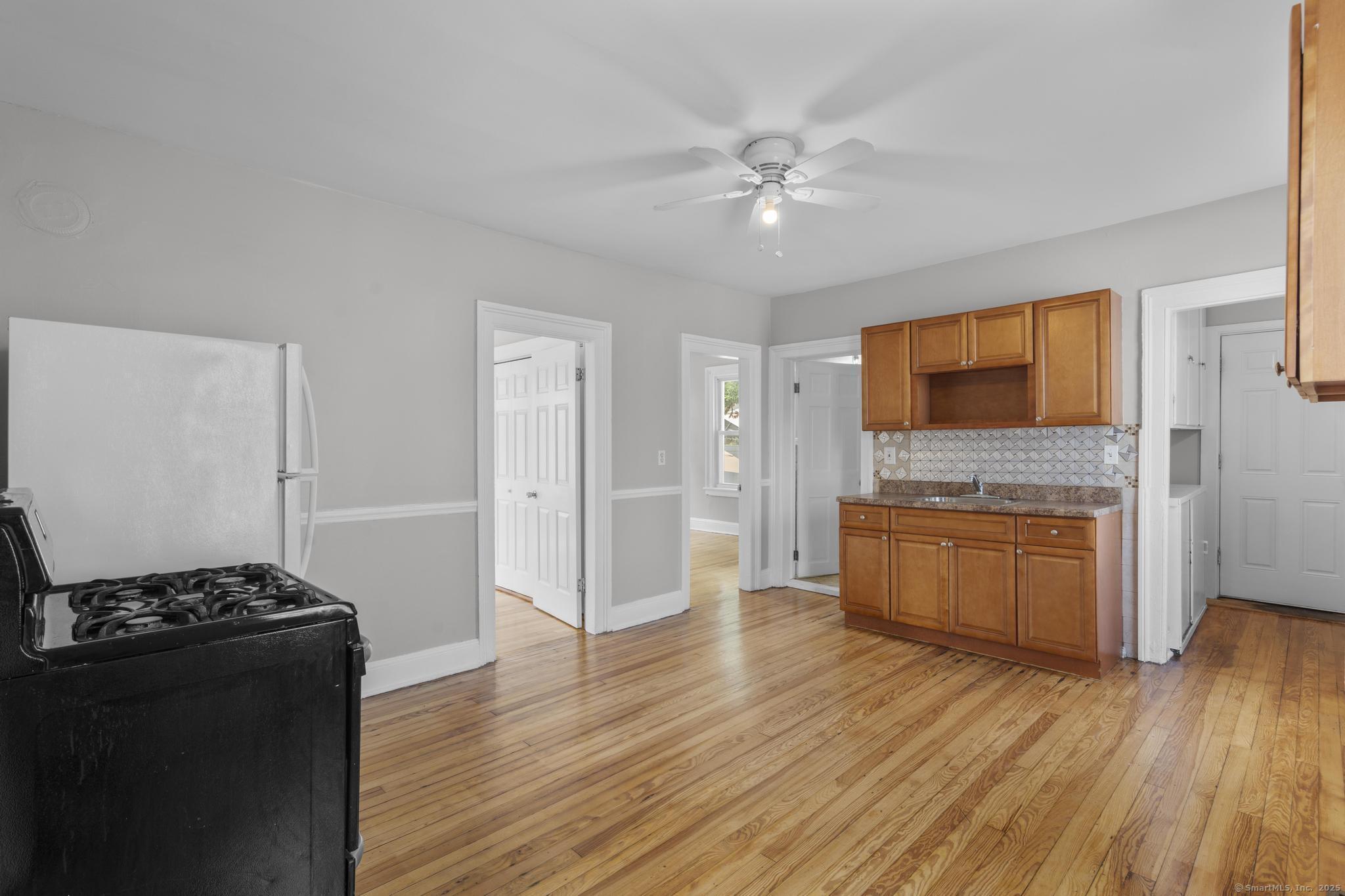 857 Noble Avenue, Unit 1 Bridgeport, CT 06608 - Photo 8 of 16 a kitchen with a refrigerator and a stove top oven