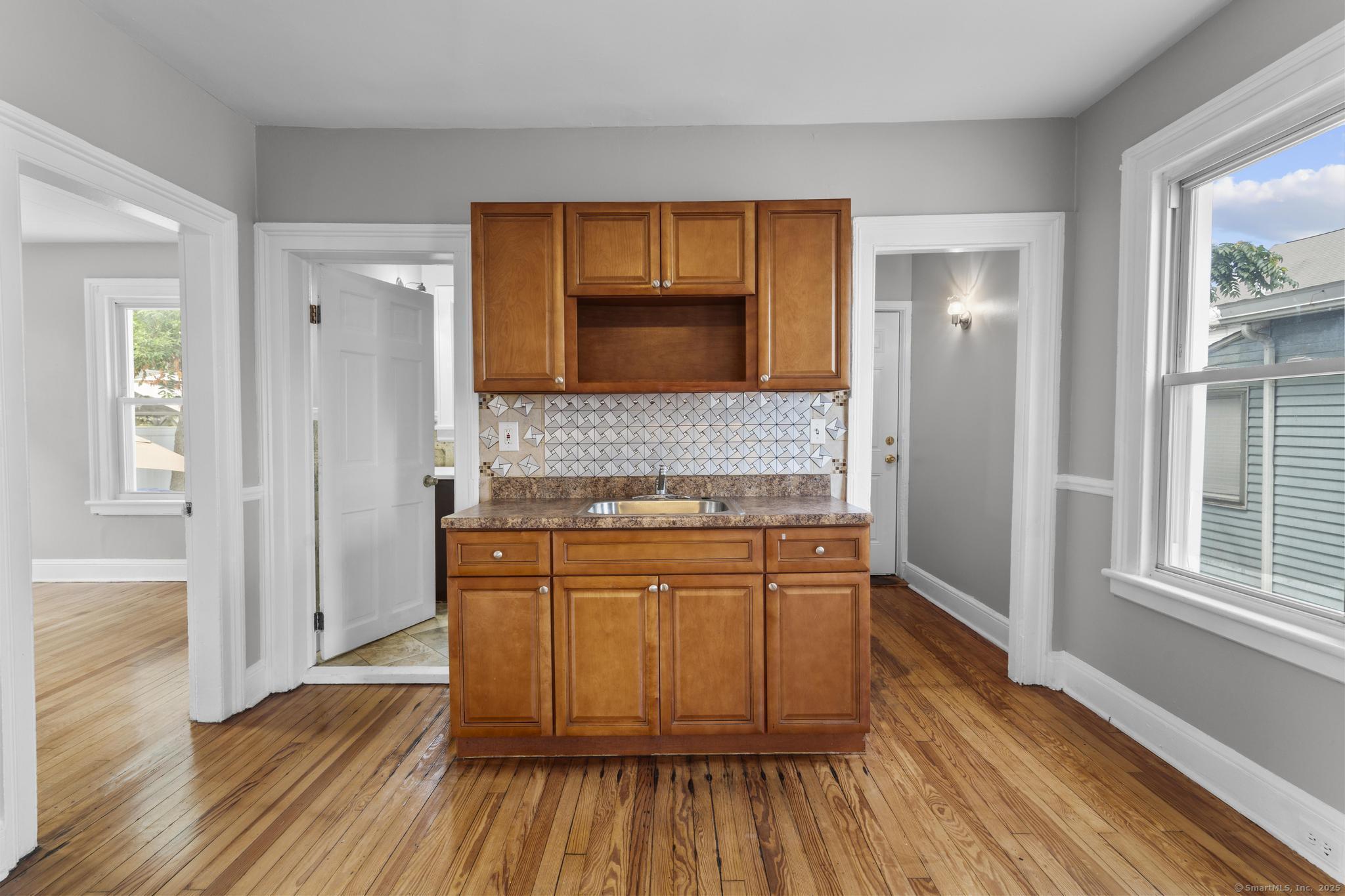 857 Noble Avenue, Unit 1 Bridgeport, CT 06608 - Photo 9 of 16 a kitchen with wooden floors and granite counter tops