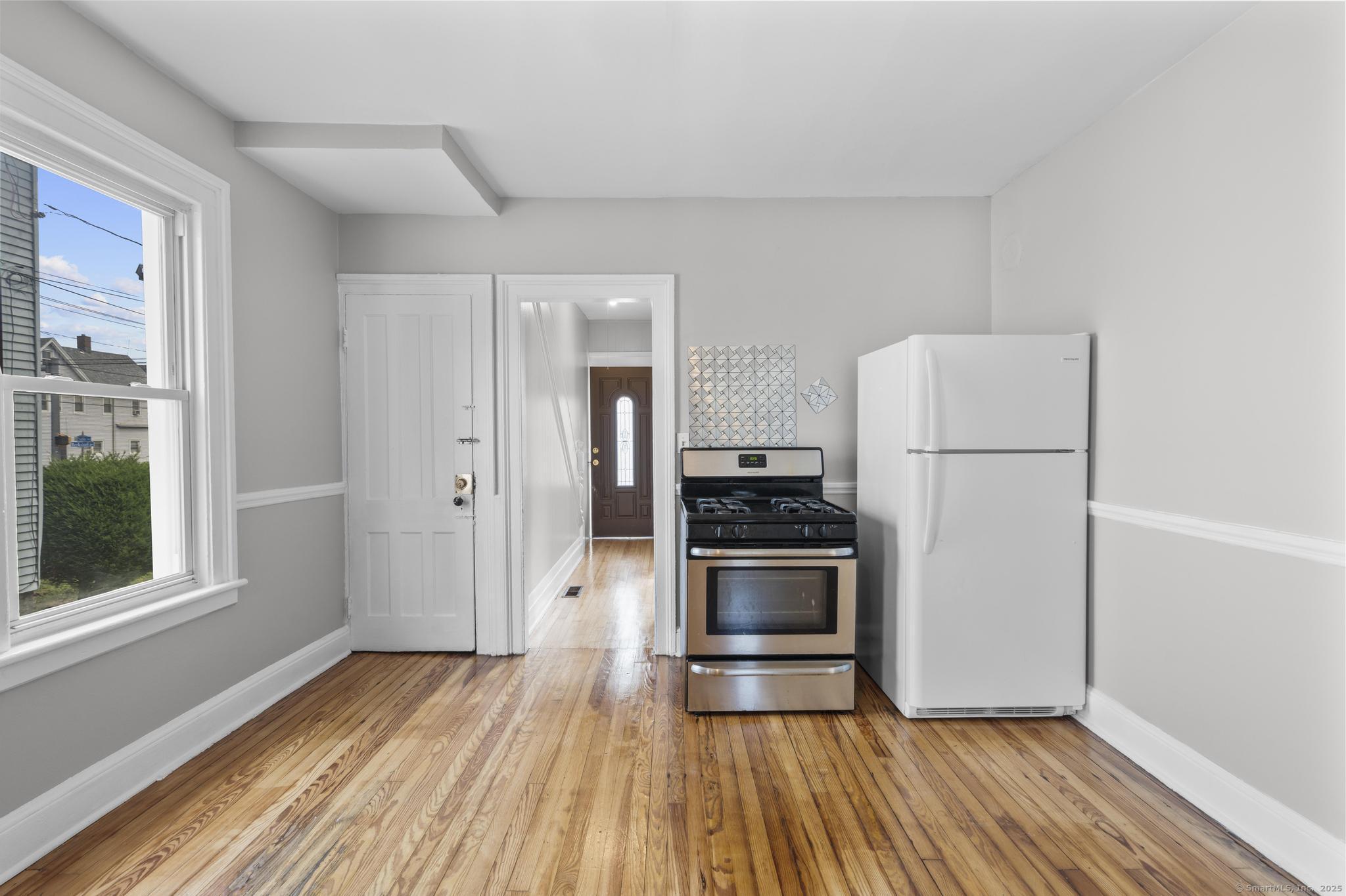 857 Noble Avenue, Unit 1 Bridgeport, CT 06608 - Photo 10 of 16 a kitchen with a refrigerator and wooden floor