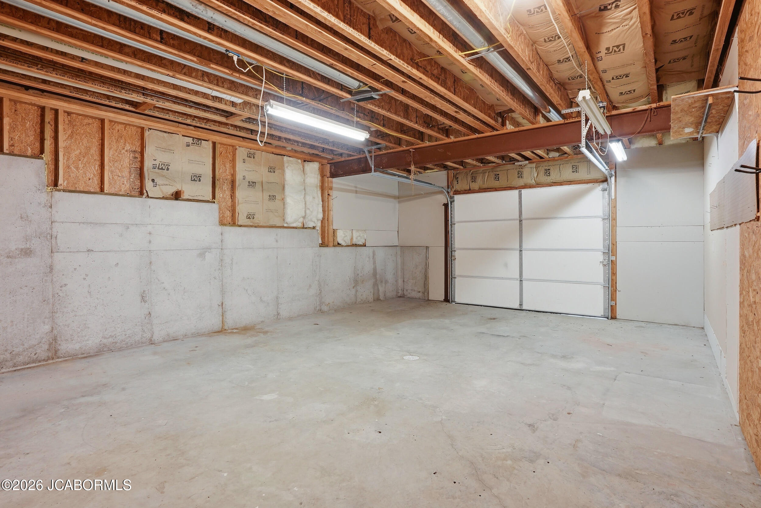 1192 Choctaw Ridge Drive Holts Summit, MO 65043 - Photo 43 of 48 Unfinished Basement w/Overhead Door