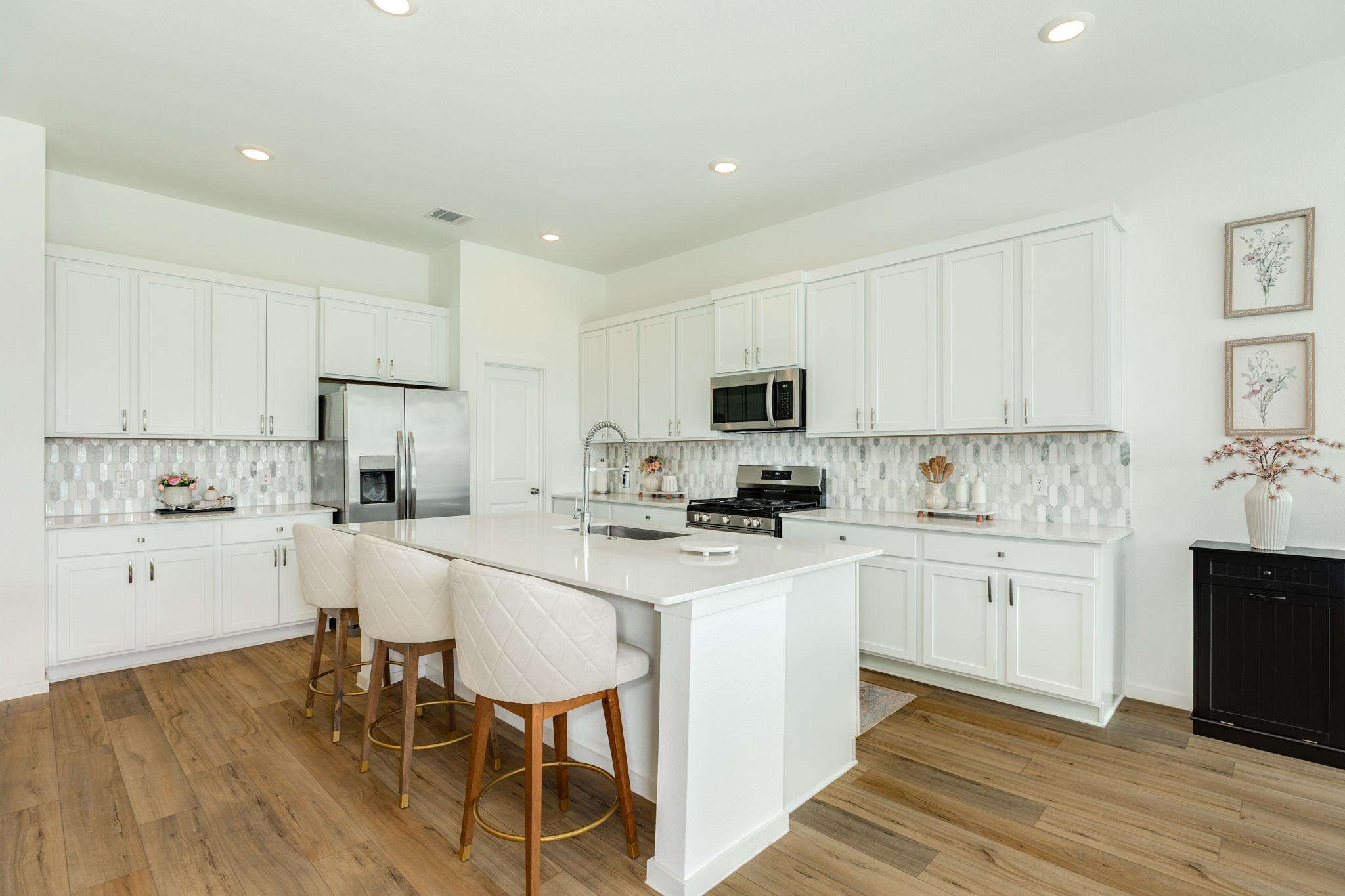 2618 Jasper Oaks Drive Rosharon, TX 77583 - Photo 14 of 43 a kitchen with white cabinets and stainless steel appliances