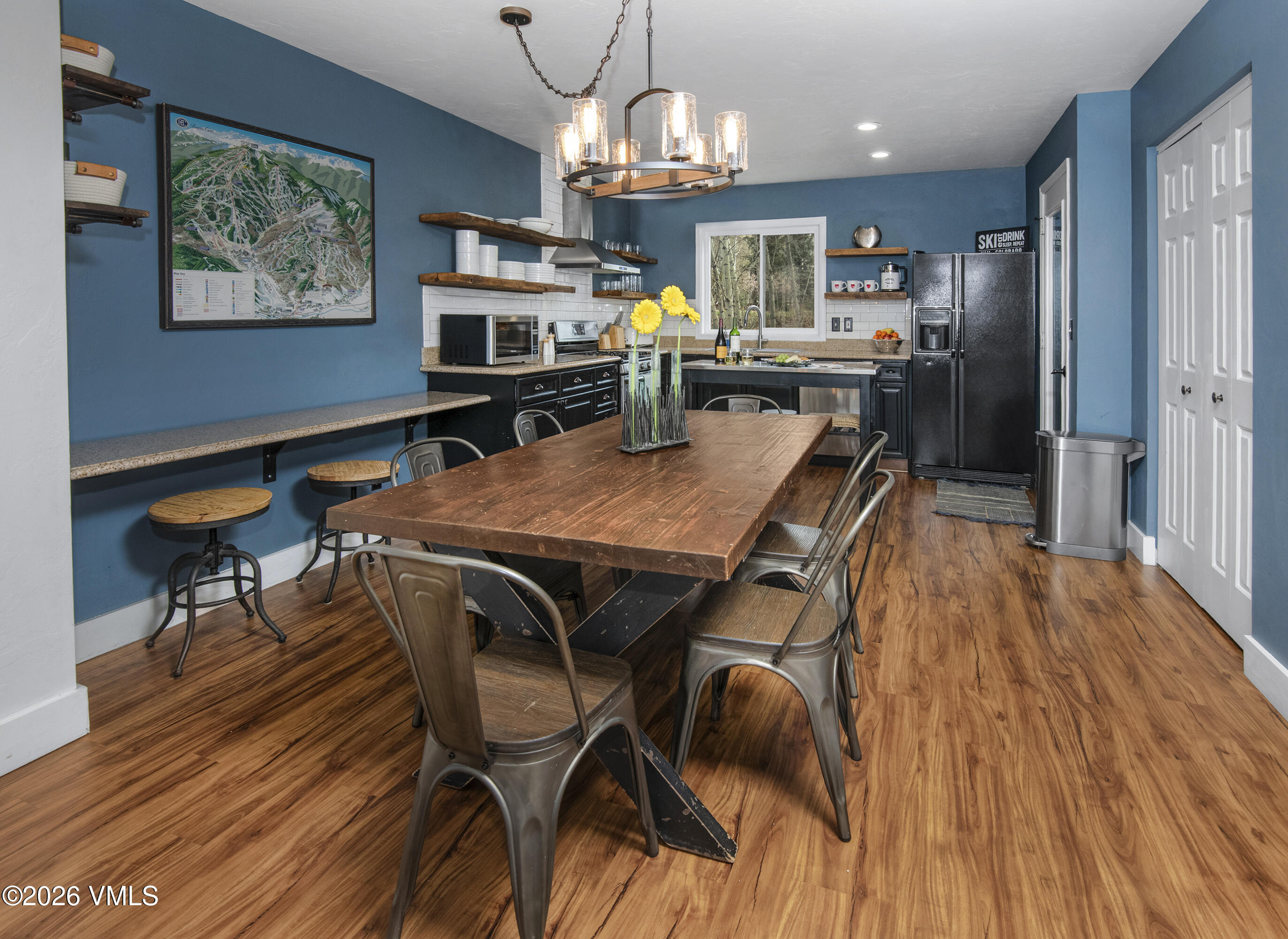 83 Arlington Place, Unit A2 Edwards, CO 81632 - Photo 5 of 19 a view of a dining room with furniture a chandelier and wooden floor