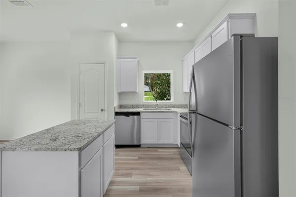 a kitchen with a refrigerator and a sink