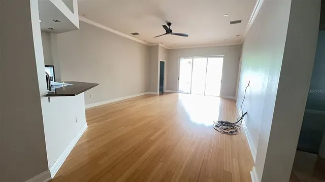 a view of empty room with wooden floor