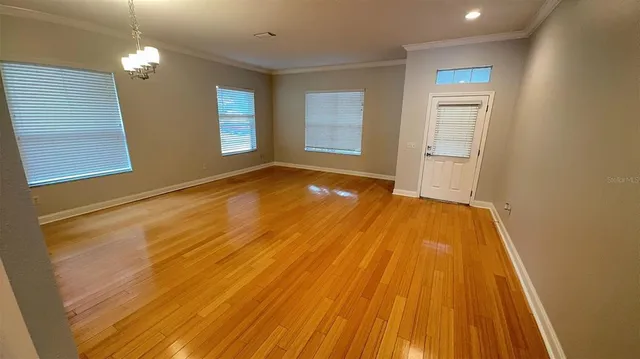 a view of a room with wooden floor and window