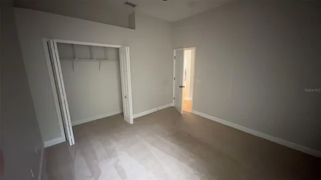 an empty room with closet area