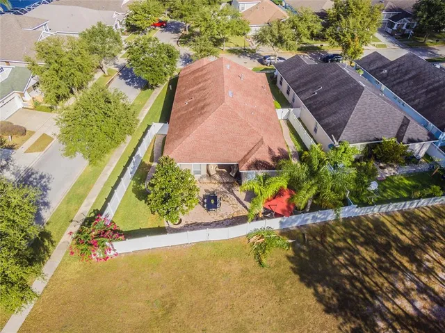 an aerial view of a house with a yard and swimming pool