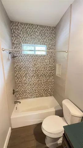 a bathroom with a toilet and a bathtub