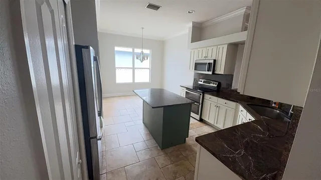 a kitchen with a refrigerator and a sink