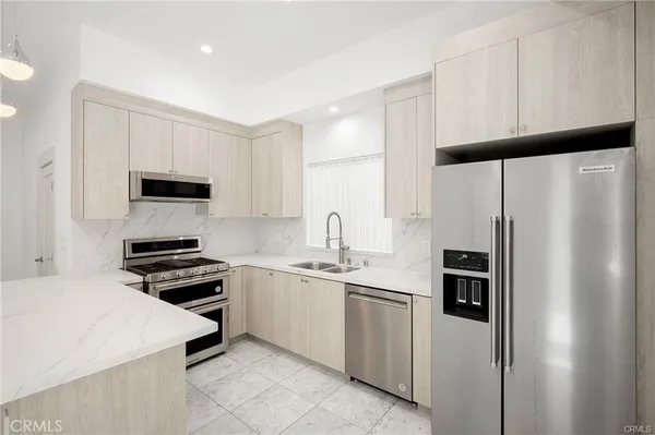 a kitchen with a refrigerator stove and sink