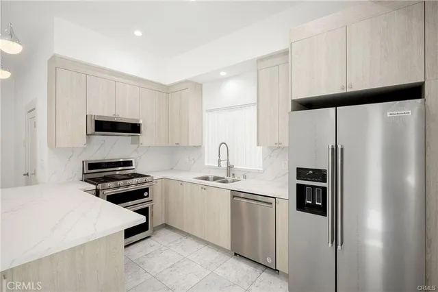 a kitchen with a refrigerator stove and sink