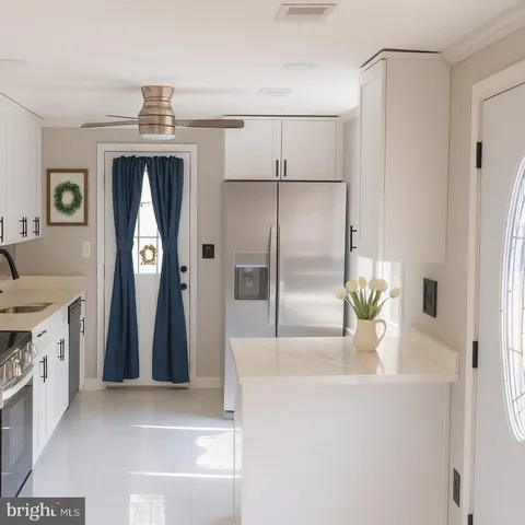 a view of kitchen with furniture and refrigerator