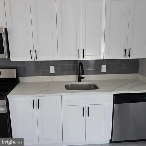 a kitchen with a sink and cabinets