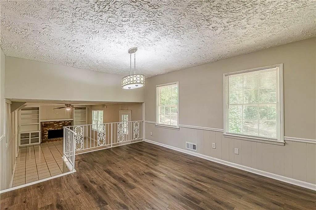 3661 Boring Road Decatur, GA 30034 - Photo 13 of 41 an empty room with wooden floor fireplace and windows