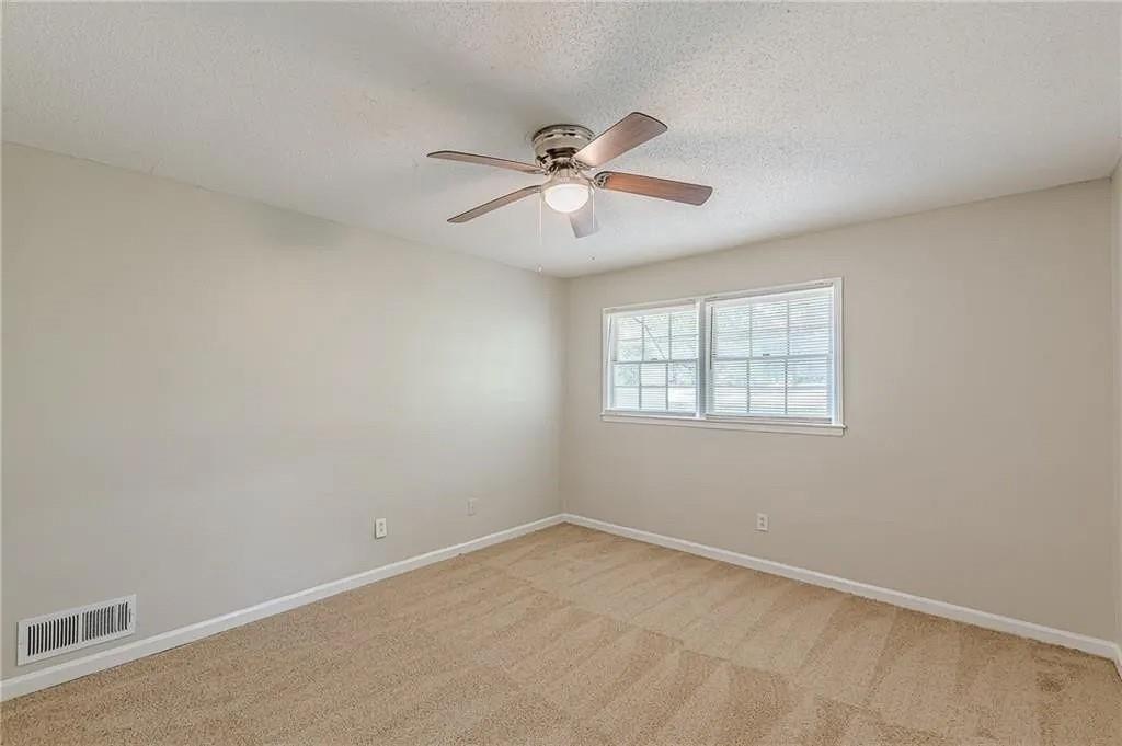 3661 Boring Road Decatur, GA 30034 - Photo 20 of 41 an empty room with a window and a fan