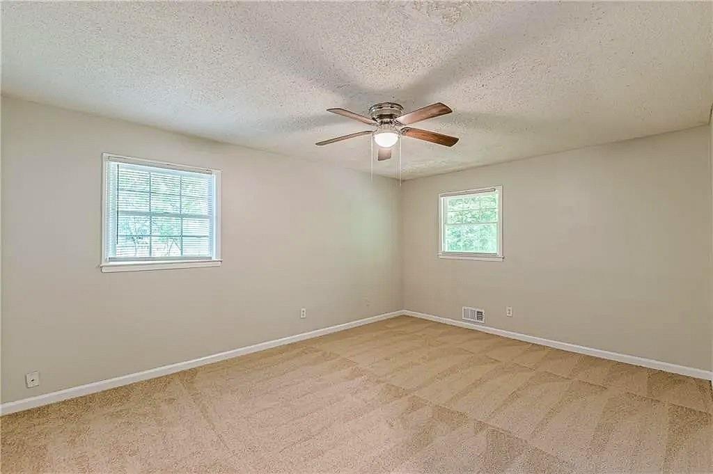 3661 Boring Road Decatur, GA 30034 - Photo 21 of 41 an empty room with windows and ceiling fan