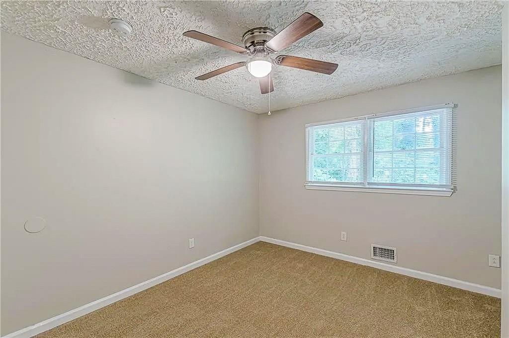 3661 Boring Road Decatur, GA 30034 - Photo 30 of 41 an empty room with a window and a fan