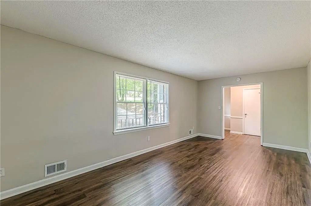 3661 Boring Road Decatur, GA 30034 - Photo 6 of 41 an empty room with wooden floor and windows