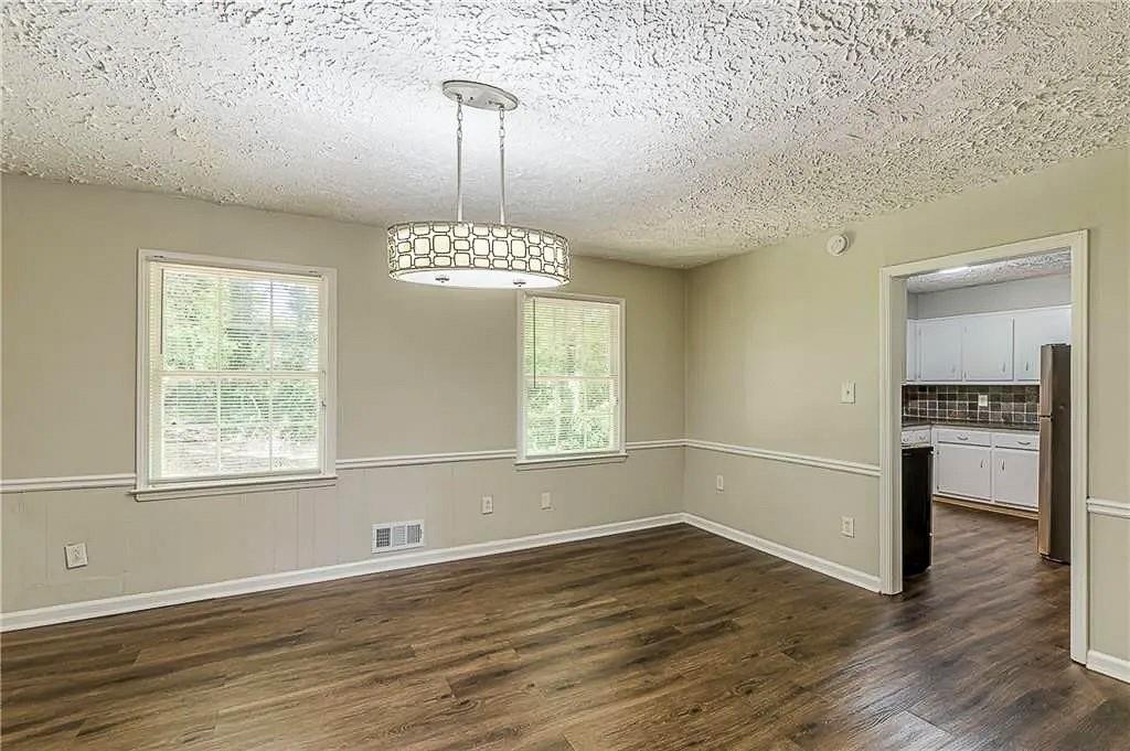 3661 Boring Road Decatur, GA 30034 - Photo 8 of 41 a view of an empty room with window and wooden floor