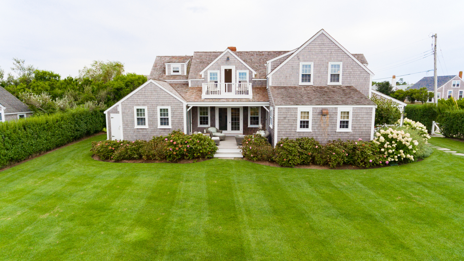 57 Quidnet Road Nantucket, MA 02554 - Photo 6 of 6 a front view of a house with garden