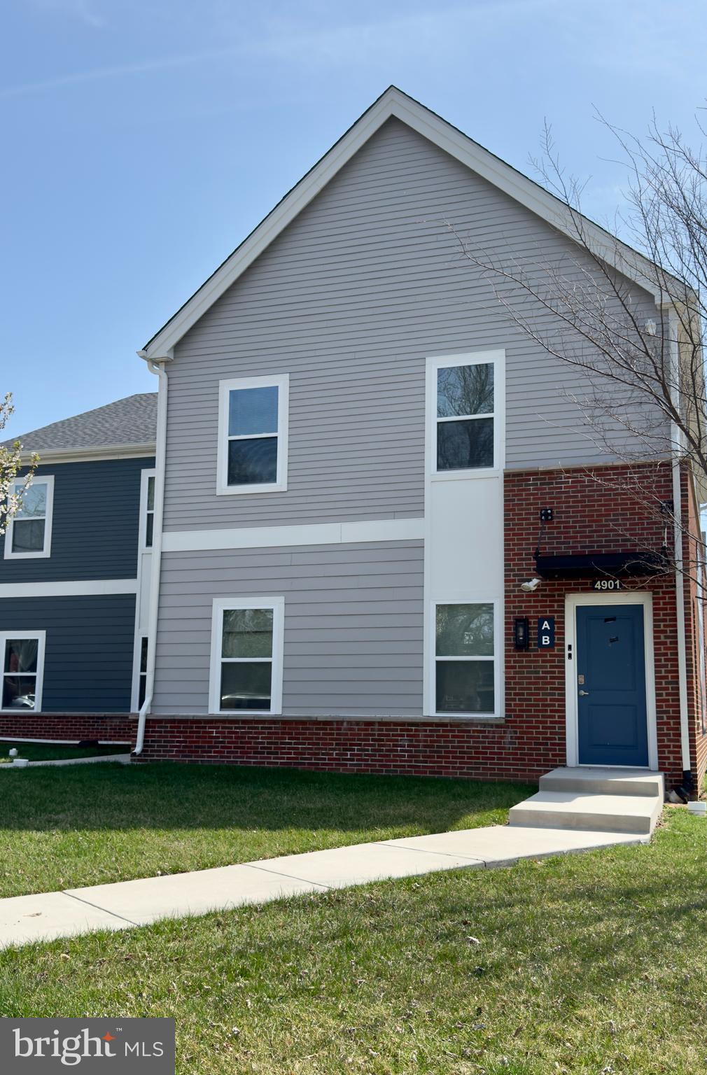 4901 Hamilton Avenue, Unit 4901B Baltimore, MD 21206 - Photo 1 of 10 a front view of a house with a yard and garage
