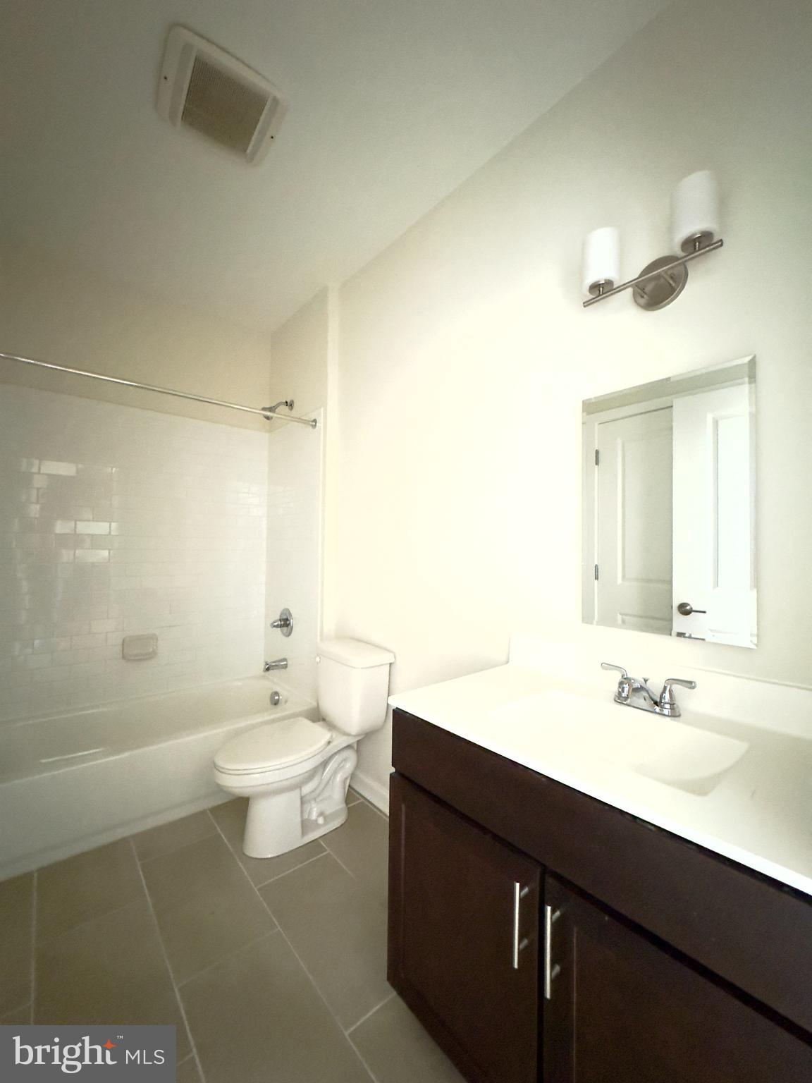 4901 Hamilton Avenue, Unit 4901B Baltimore, MD 21206 - Photo 8 of 10 a bathroom with a sink a toilet and shower