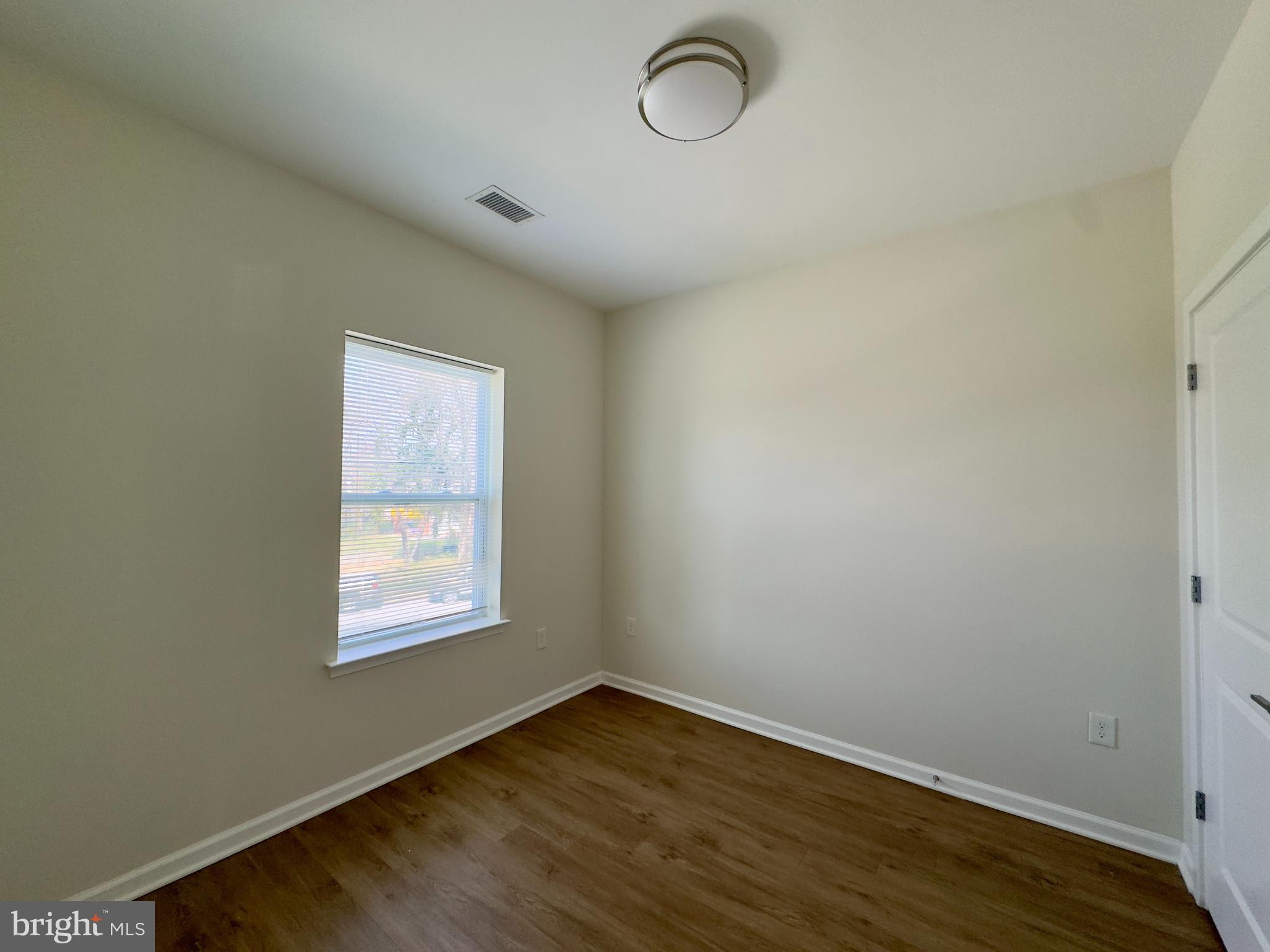 4901 Hamilton Avenue, Unit 4901B Baltimore, MD 21206 - Photo 10 of 10 a view of a room with wooden floor and windows