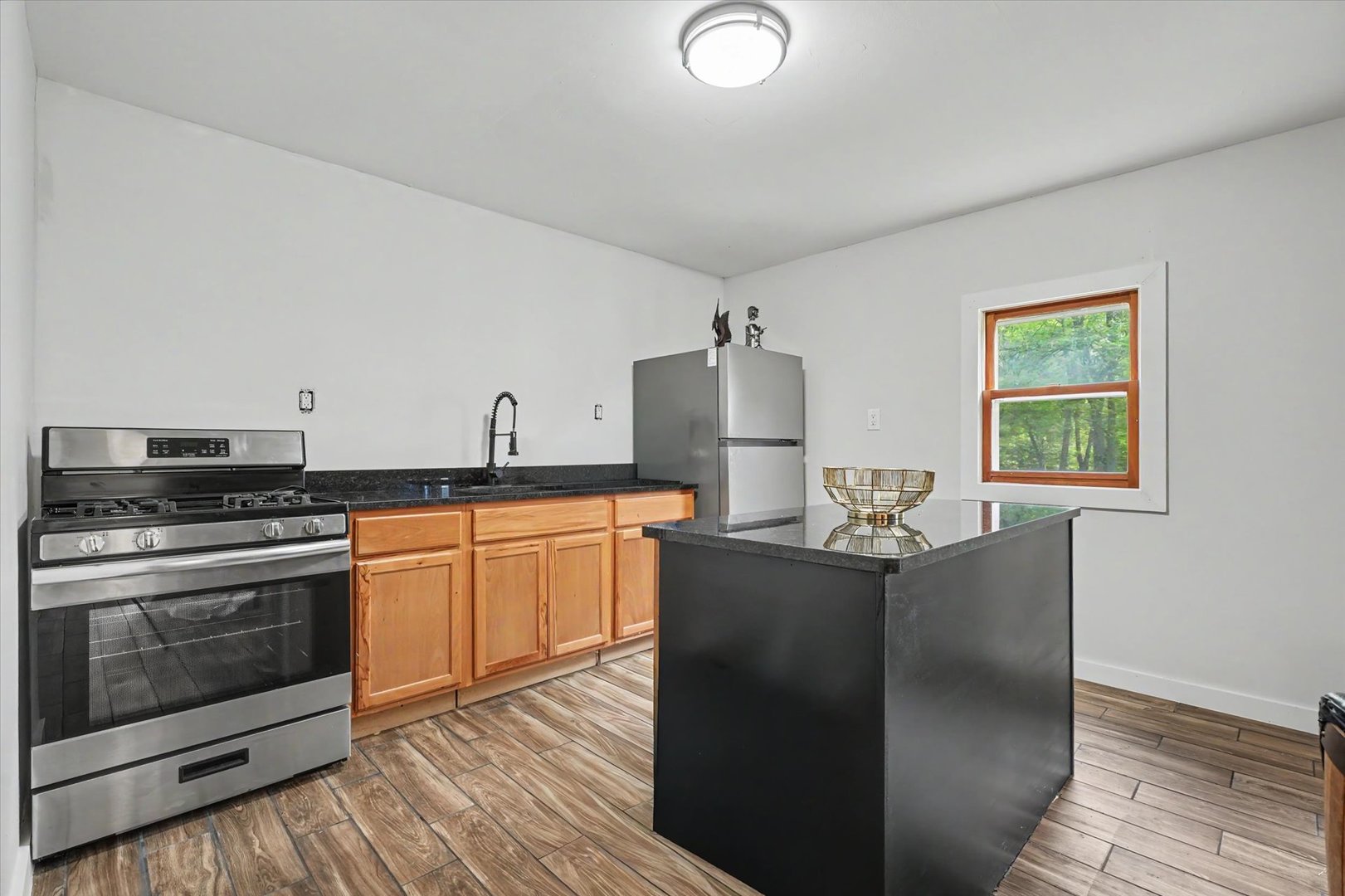 2431 North 1450 East Road Mansfield, IL 61854 - Photo 48 of 78 a kitchen with stainless steel appliances granite countertop a stove a sink and a refrigerator