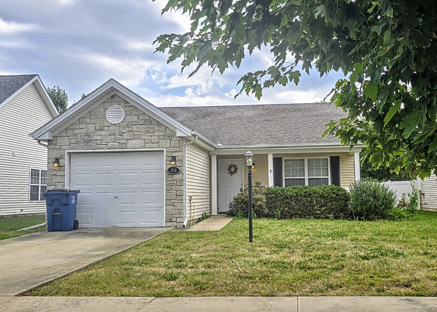 609 Corey Lane Champaign, IL 61822 - Photo 1 of 10 a front view of a house with a garden