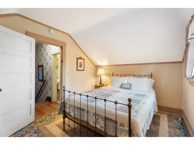 a bedroom with two beds and a desk