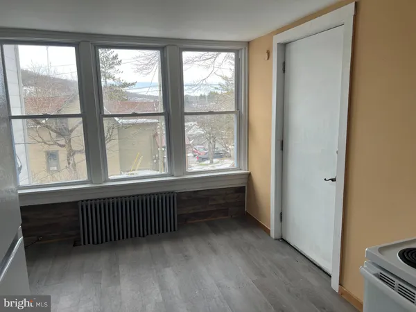 a view of an empty room and wooden floor