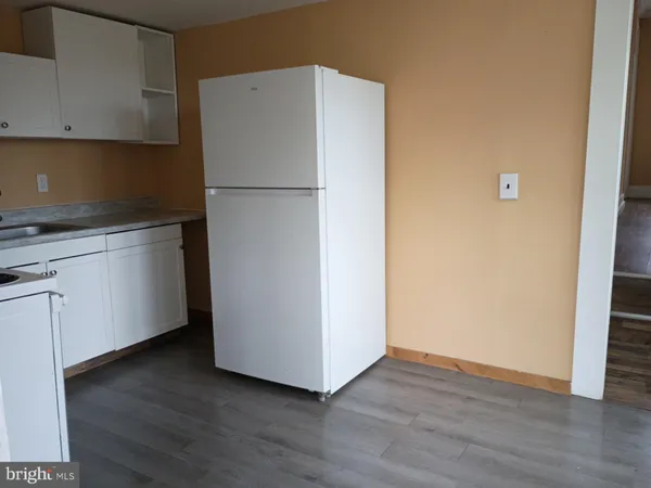 a white refrigerator freezer sitting in a kitchen