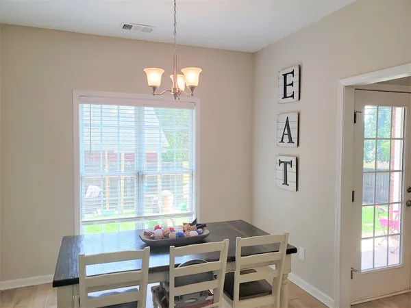 a view of a dining room with wooden floor