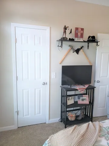 a bathroom with a granite countertop sink and a toilet