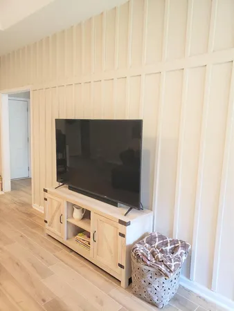 a kitchen with stainless steel appliances a stove a refrigerator a oven a dining table and chairs