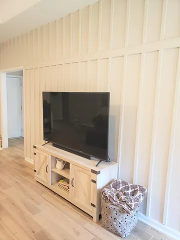 a kitchen with stainless steel appliances a stove a refrigerator a oven a dining table and chairs