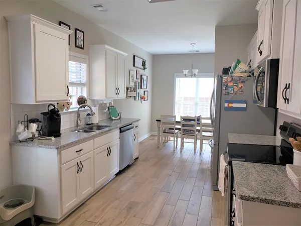 a kitchen with a sink cabinets and window