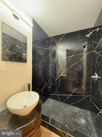 an empty room with wooden floor and a window