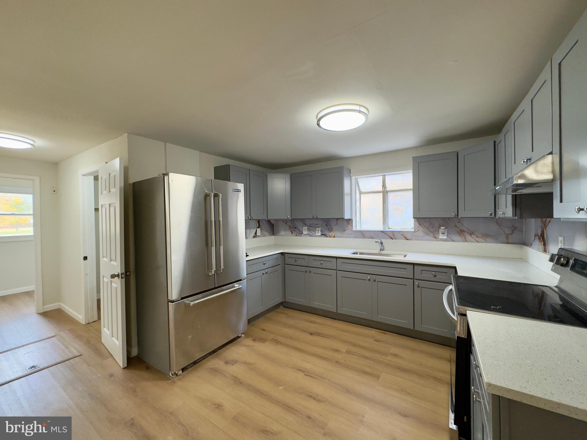 815 Seneca Park Road Middle River, MD 21220 - Photo 2 of 23 a kitchen with stainless steel appliances granite countertop a refrigerator and a sink