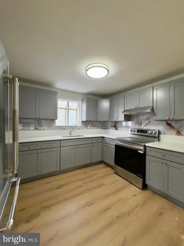 a kitchen with a sink cabinets and window