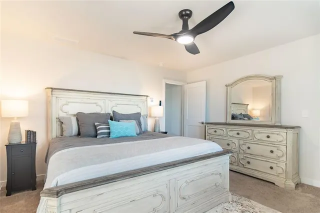 a bedroom with a large bed and a chandelier